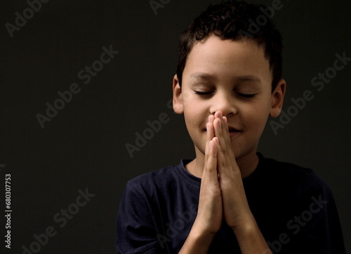 boy praying to God with hands held together with people sock image stock photo 