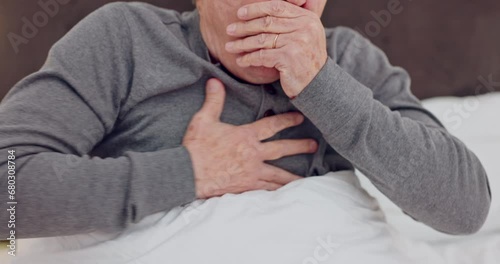 Senior man coughing with chest infection, allergies or sickness in bed in retirement home. Medical, recovery and closeup of elderly male patient resting with cold or sickness in his modern house. photo