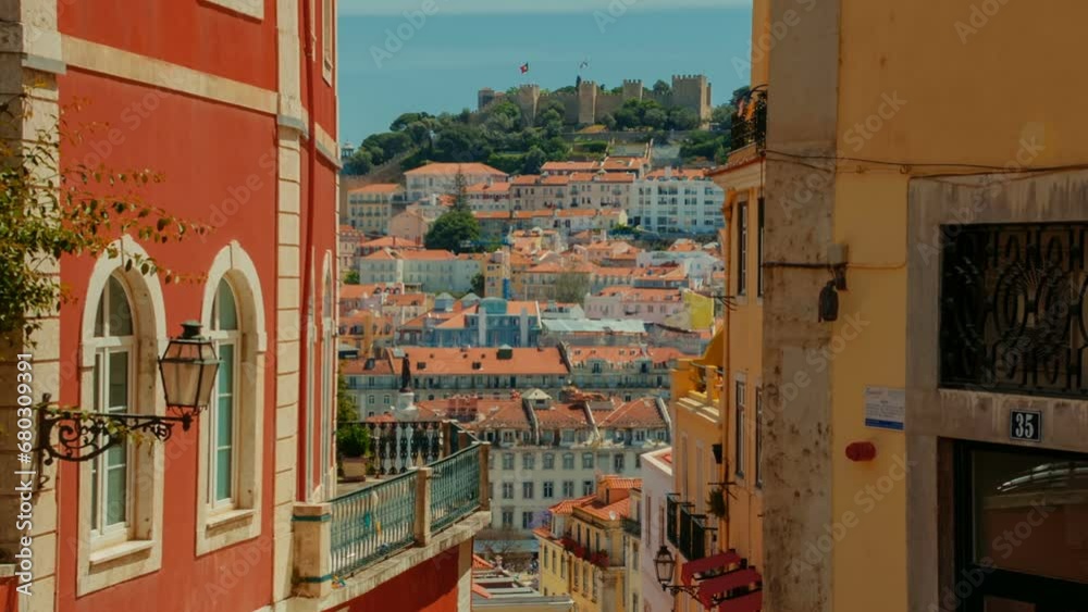 Tilting establishing shot of the downtown of Lisbon, Portugal showing the Castelo de Sao Jorge castle