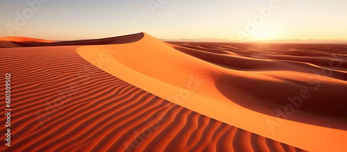 background, the sun casts a mesmerizing shadow on the endless desert, highlighting the natural beauty and texture of Africas wilderness, creating an awe-inspiring pattern that resembles an artwork a