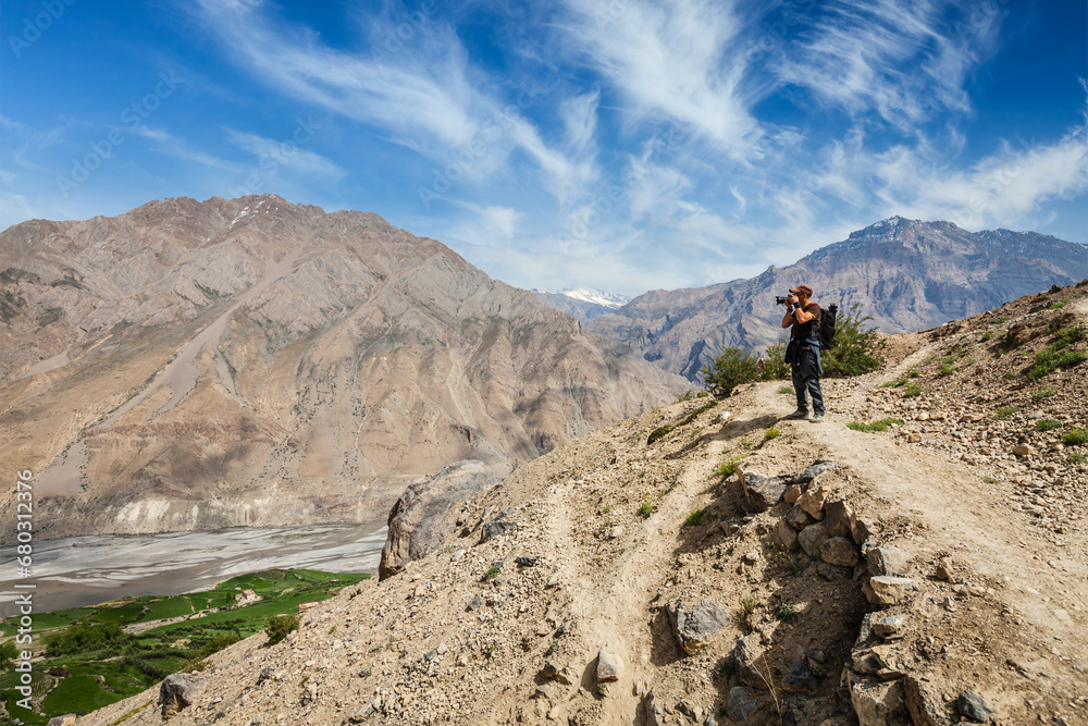 Photographer taking photos in Himalayas mountains. Spiti valley, Himachal Pradesh, India