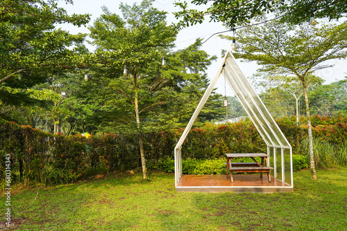 Wallpaper Mural Minimalist White glass canvas gazebo with wooden table chairs garden furniture on summer green lawn. Torontodigital.ca