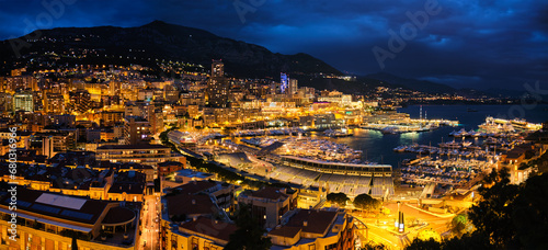 Aerial panorama of Monaco Monte Carlo harbour and illuminated city skyline in the evening blue hour twilight. Monaco Port night view with luxurious yachts © Dmitry Rukhlenko
