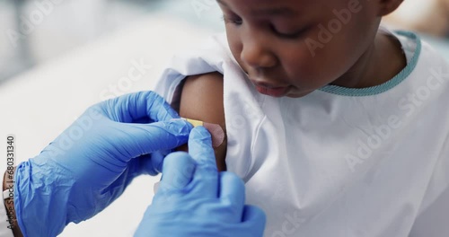 Doctor, patient and plaster for vaccine, virus protection and immunization booster or flu shot. Black child, injection and bandage on wound, medicine and treatment for health, trust and support photo