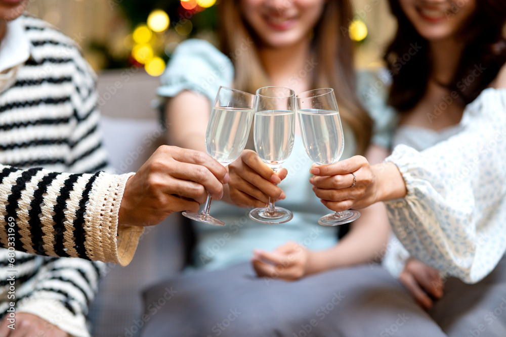 group of friends raise a glass of champagne celebrated in a fun party