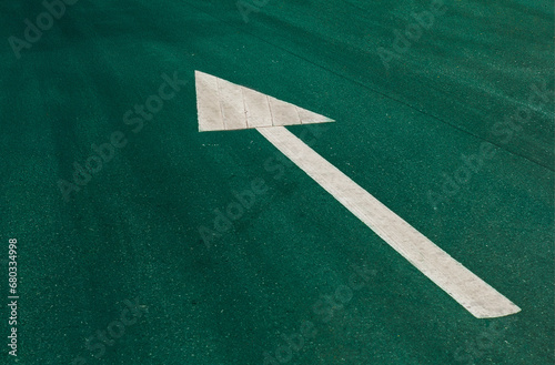 The road surface is a forward sign. white arrow on green background