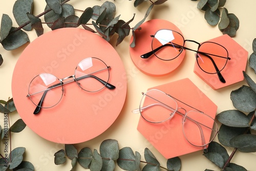 Flat lay composition with different stylish glasses on beige background photo