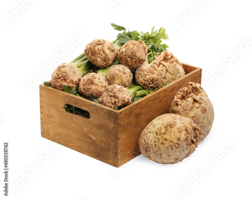 Wooden crate and fresh raw celery roots isolated on white