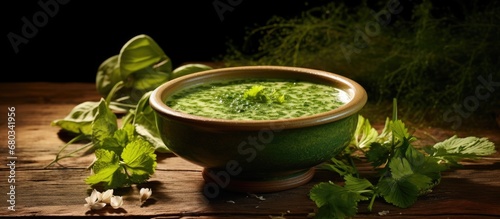 In the springtime of Country, one can savor the refreshing flavors of a healthy Countryn green soup, crafted with traditional herbs and Urtica leaves for a nutritious and creamy meal. photo