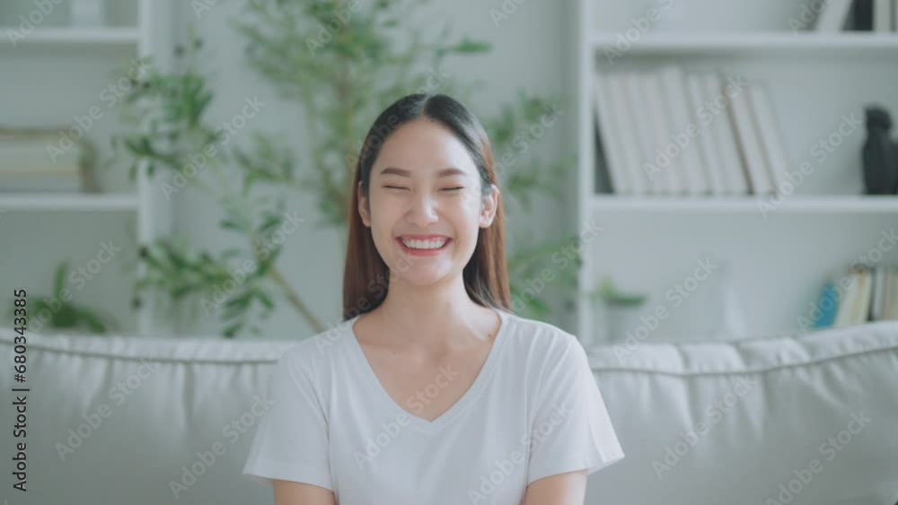 Front view of a cute young Asian woman smiling and looking at the camera. Happy facial expressions and positive emotions Front view of a cute young Asian woman smiling and looking at the camera. Happy facial expressions and positive emotions