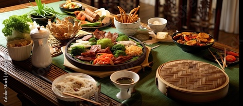 At the Chinese holiday celebration, a variety of healthy dishes were served on bamboo plates, including rice, meat, and leafy vegetables. The wooden table was adorned with China-inspired decorations