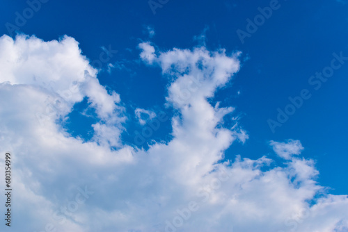 beautiful blue sky and white fluffy group of clouds with sunrise in the morning  natural background