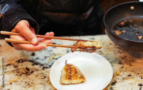 wooden chopsticks resting on a ceramic dish, depicting Asian dining culture and traditional utensils in a minimalistic setting
