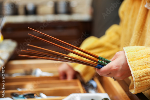 wooden chopsticks resting on a ceramic dish, depicting Asian dining culture and traditional utensils in a minimalistic setting photo