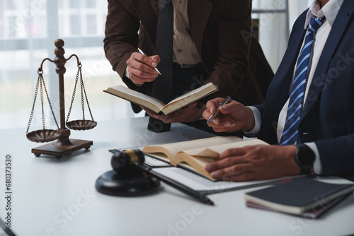 Lawyer, legal advisor, businessman brainstorming information on agreement details Business contracts in legal processing books for accuracy in contract documents. joint financial investment. photo