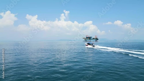 Aerial orbiting shot of a small celebes sea boat heading out to sea with divers photo