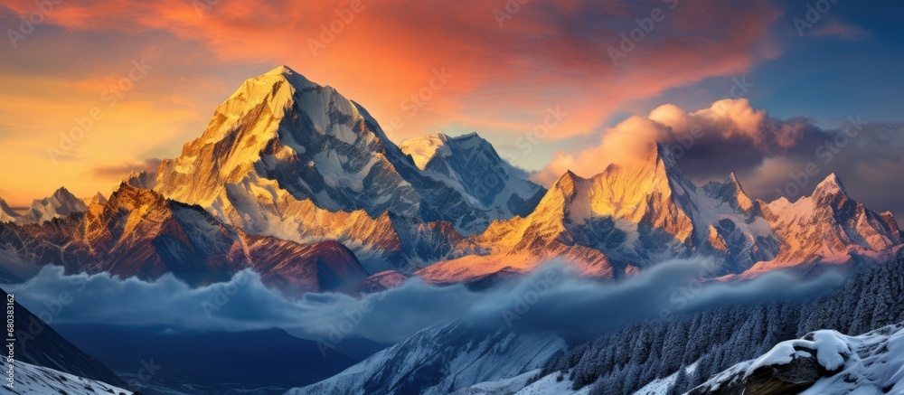 As the sun rises above the breathtaking Himalaya mountains, the panoramic view of Indias majestic nature unfolds, with its pristine white snow-capped peaks piercing the clear blue sky, contrasting