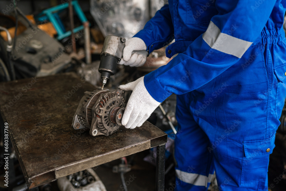 Closeup of auto mechanic are using the wrench to repair and maintenance auto engine is problems at car repair shop. Closeup of auto mechanic are using the wrench to repair and maintenance auto engine is problems at car repair shop.