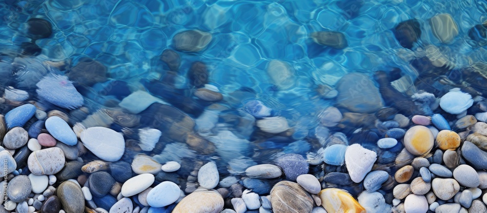 In the depths of summer, amidst the vibrant colors of nature, a mesmerizing pattern of waves forms, its blue hues reflecting a lively energy. The circular shape of each wave creates a captivating In the depths of summer, amidst the vibrant colors of nature, a mesmerizing pattern of waves forms, its blue hues reflecting a lively energy. The circular shape of each wave creates a captivating