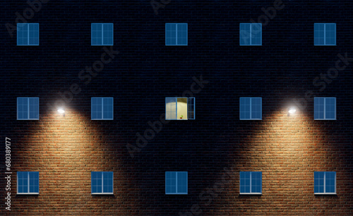 The light is on in one open window of a large multi-story residential building.