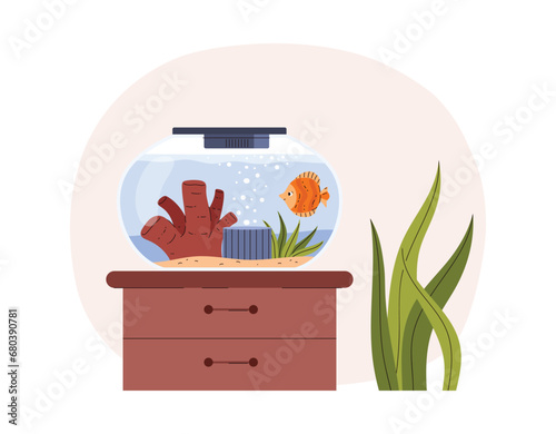 Round aquarium with cute yellow swimming fish stands on nightstand