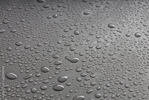 water droplets of various sizes are arranged randomly on a black background