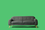 Modern grey sofa on green background