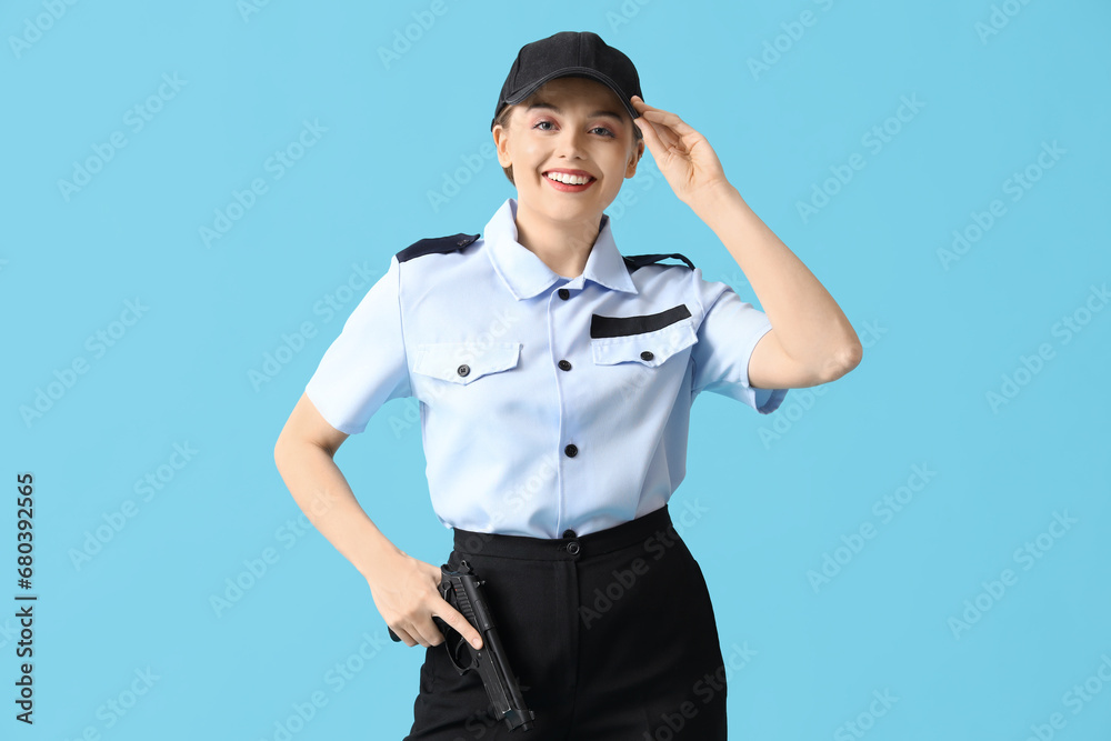 Female police officer with gun on blue background Female police officer with gun on blue background