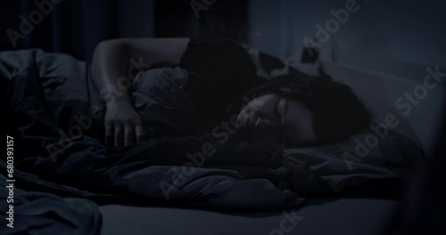 Close up of woman tossing and turning in bed at night