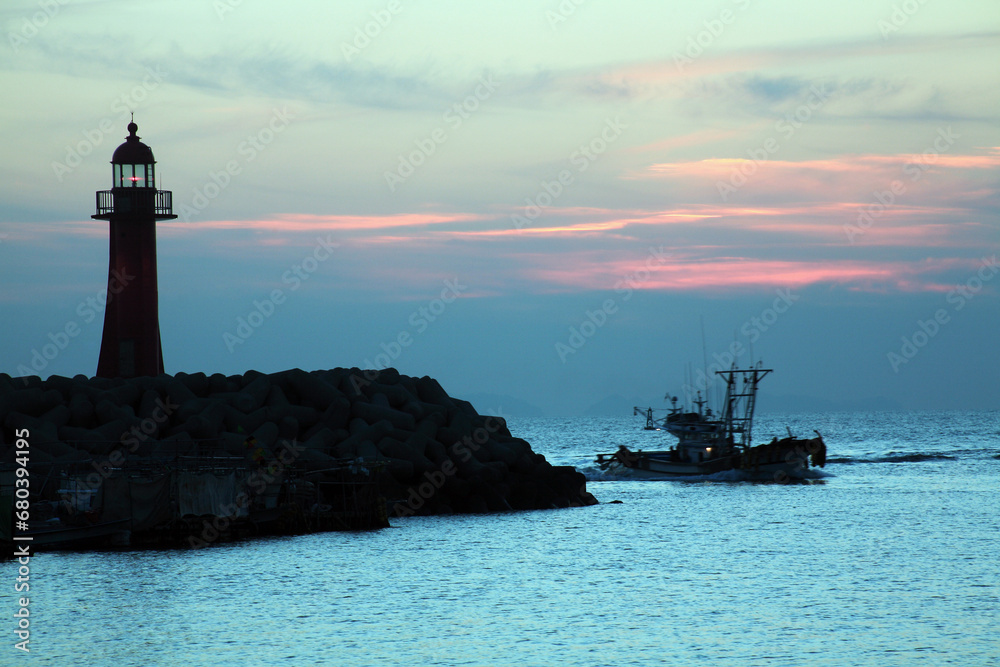 lighthouse and fishing boat
