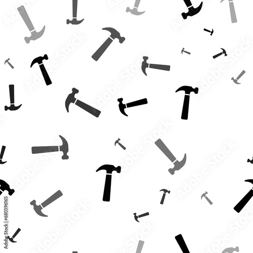 Seamless vector pattern with hammer symbols, creating a creative monochrome background with rotated elements. Illustration on transparent background