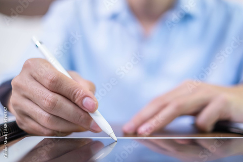 Closeup hand pen writing black screen background digital tablet technology work office business person, online internet job businessman using planning stylus electronic device note document