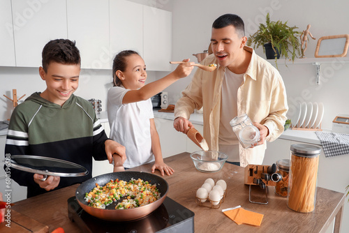 Happy family cooking in kit...