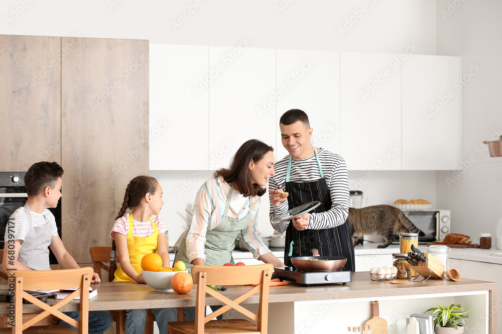 Happy family cooking in kitchen Happy family cooking in kitchen