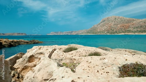 Low angle POV tracking shot along the beautiful rugged coast of Balos beach in Crete, Greece, featuring prominent turquoise waters photo