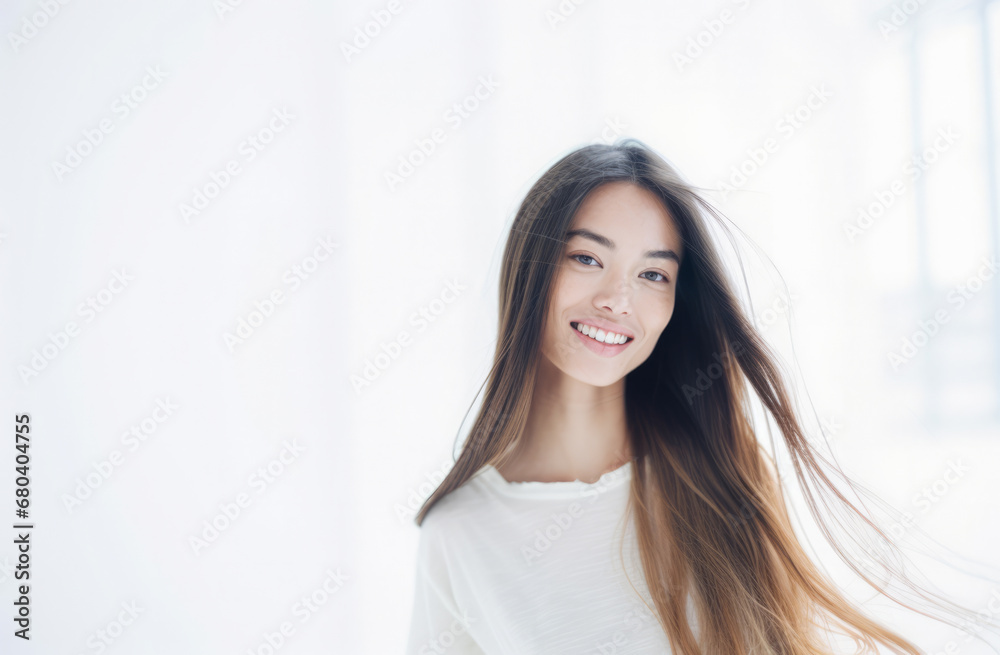 Portrait of a young beautiful asian woman isolated from a bright background Portrait of a young beautiful asian woman isolated from a bright background