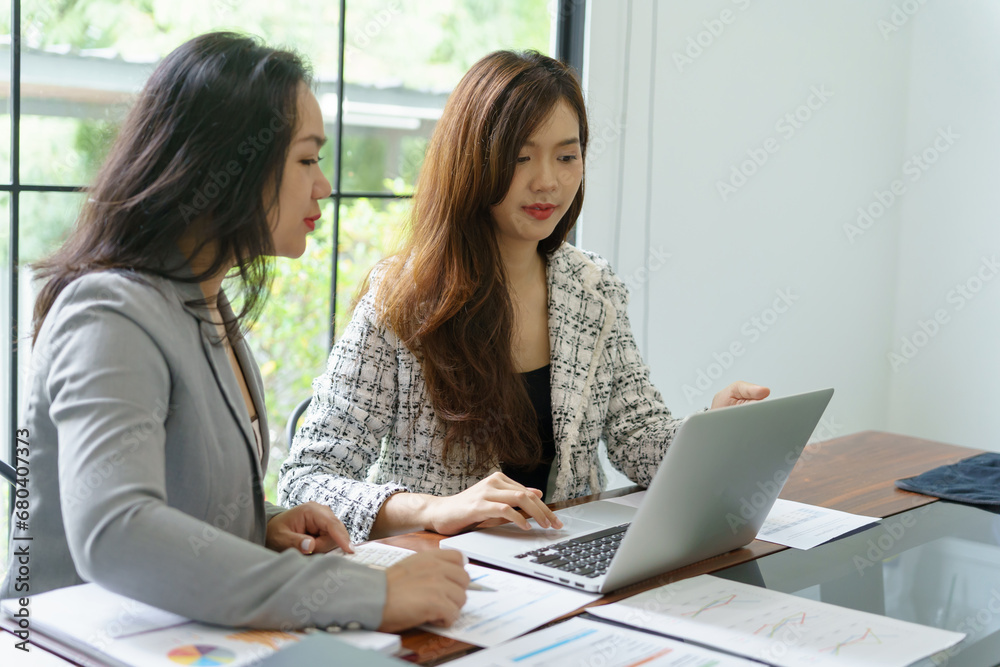 Businesswoman Accountant analyzing investment charts Invoice and pressing calculator buttons over documents. Accounting Bookkeeper Clerk Bank Advisor And Auditor Businesswoman Accountant analyzing investment charts Invoice and pressing calculator buttons over documents. Accounting Bookkeeper Clerk Bank Advisor And Auditor