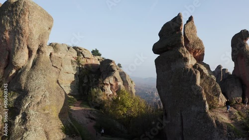 Fly-through aerial drone shot going in between the huge natural rock formations of the Belogradchik clifffs, located in the province of Vidin in Bulgaria. photo