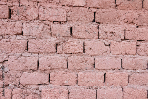 Old adobe mud brick wall in frontal view