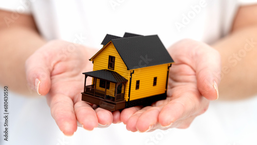 a model of a house in the hand of a realtor's girlfriend