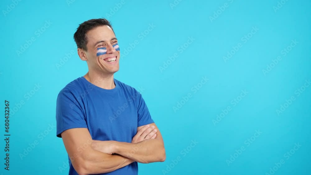 Happy man with salvadoran flag painted on face looking away Happy man with salvadoran flag painted on face looking away