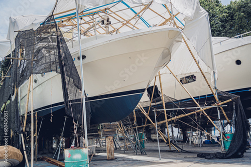 Motor yacht moored for repairs and service in dry dock