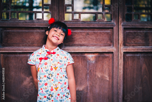 cute little asian girl in chinese traditional dress smiling