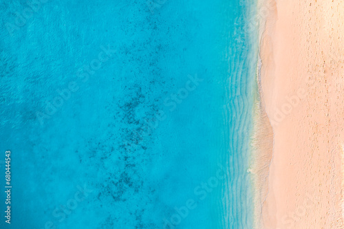 Summer seascape beautiful waves, blue sea water in sunny day. Top view from drone. Sea aerial view, amazing tropical nature background. Beautiful bright sea waves splash crash beach sand  landscape © icemanphotos