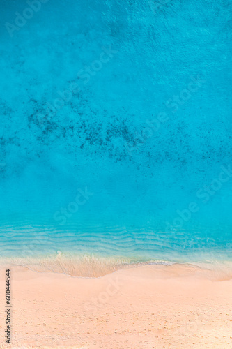 Summer seascape beautiful waves, blue sea water in sunny day. Top view from drone. Sea aerial view, amazing tropical nature background. Beautiful bright sea waves splash crash beach sand  landscape © icemanphotos