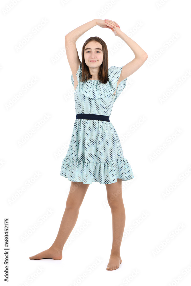 Young beautiful girl in a dress with polka dots on a white background.
