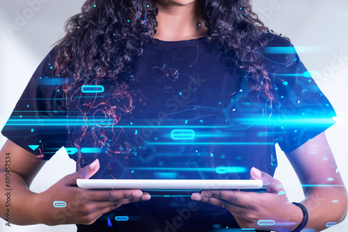 future technologies. a girl in a black T-shirt holds a tablet with holograms in her hands. devices and gadgets of the future photo