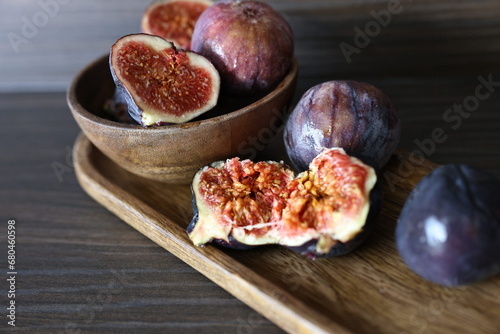 Fig fruit on a wooden plate neutral palette (ID: 680460598)