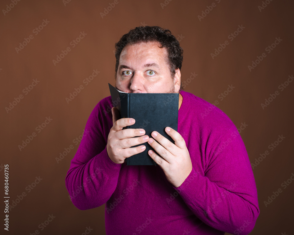 Funny librarian and important books. A man posing against a brown background. Funny librarian and important books. A man posing against a brown background.