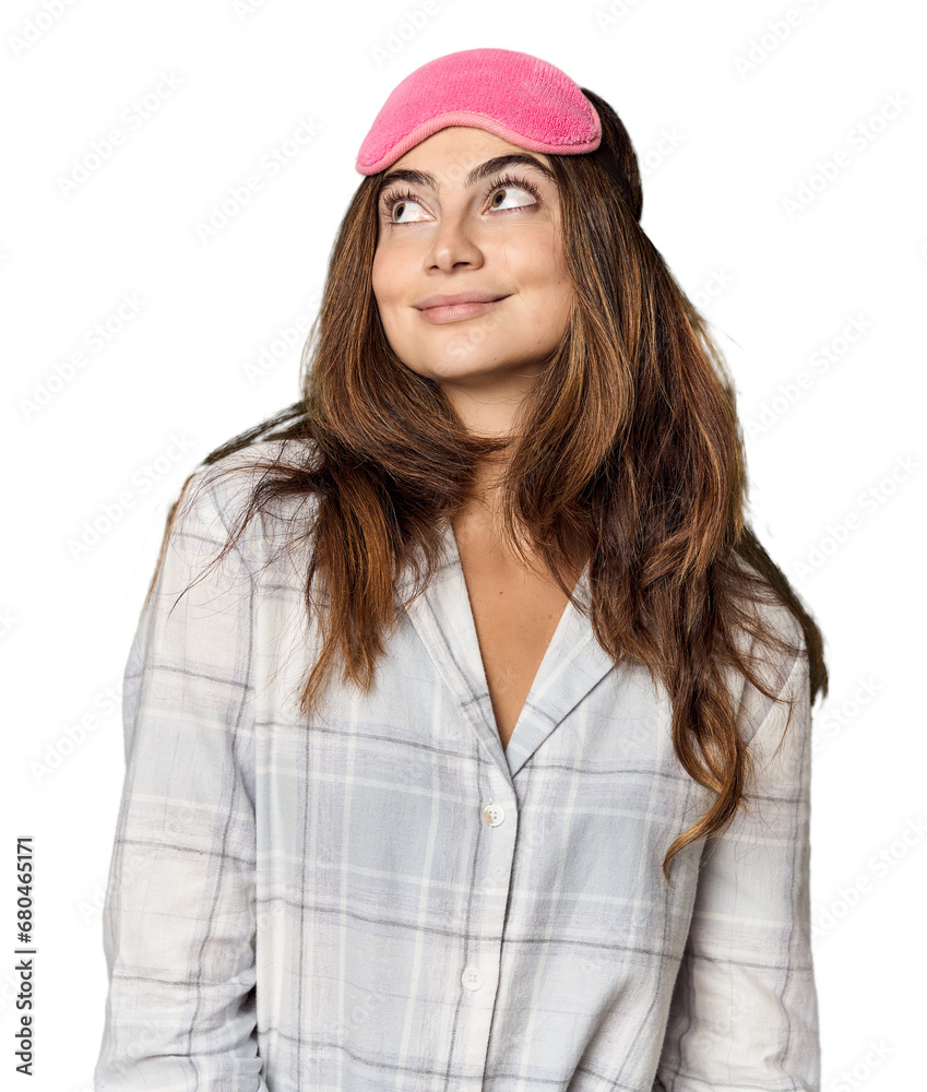 Young Caucasian woman in pajamas with mask dreaming of achieving goals and purposes Young Caucasian woman in pajamas with mask dreaming of achieving goals and purposes